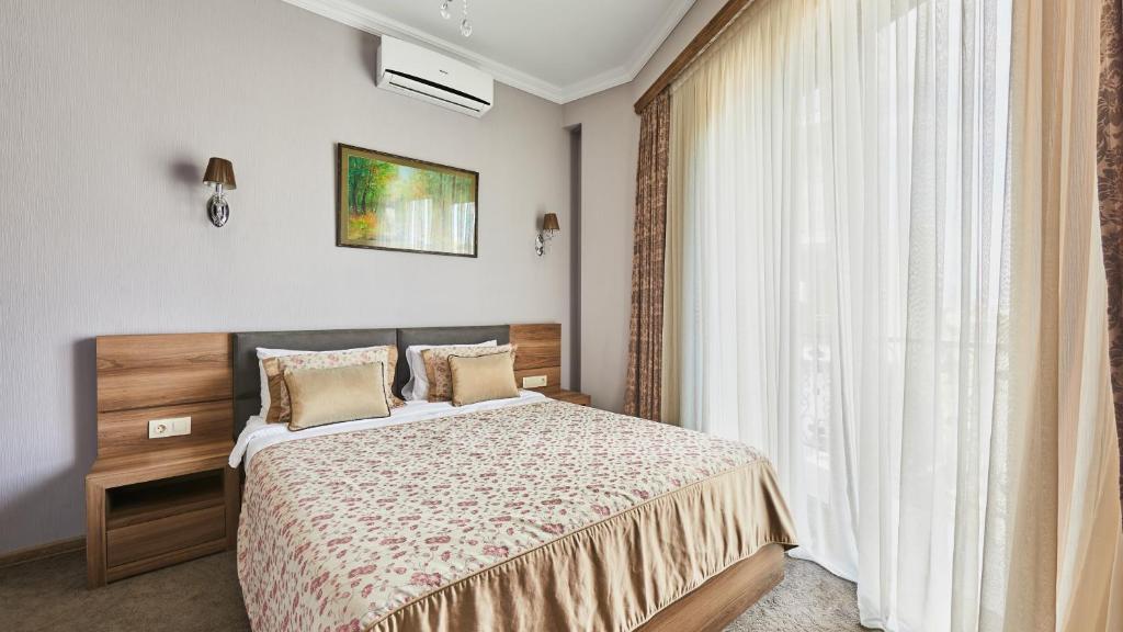 Postel nebo postele na pokoji v ubytování Hotel Pushkin