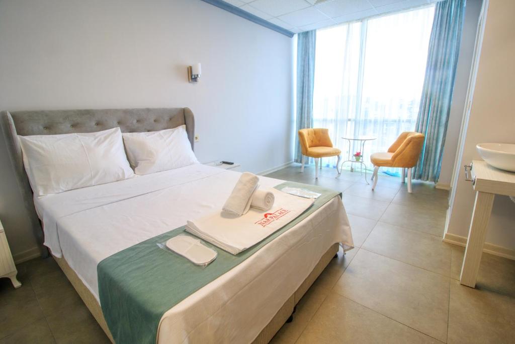 a hotel room with a bed with two towels on it at Nar Palace in Istanbul