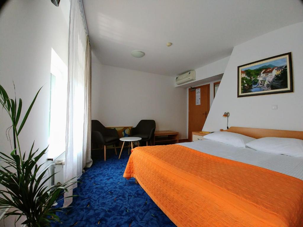 Postel nebo postele na pokoji v ubytování Hotel garni Paleta