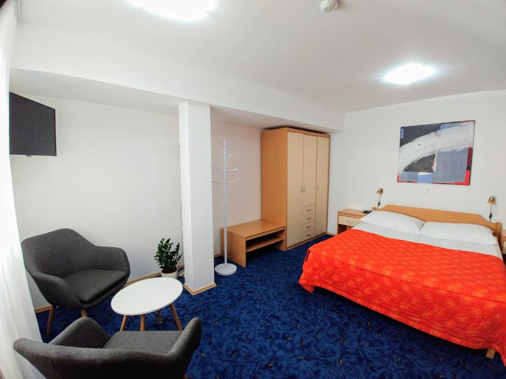 Postel nebo postele na pokoji v ubytování Hotel garni Paleta