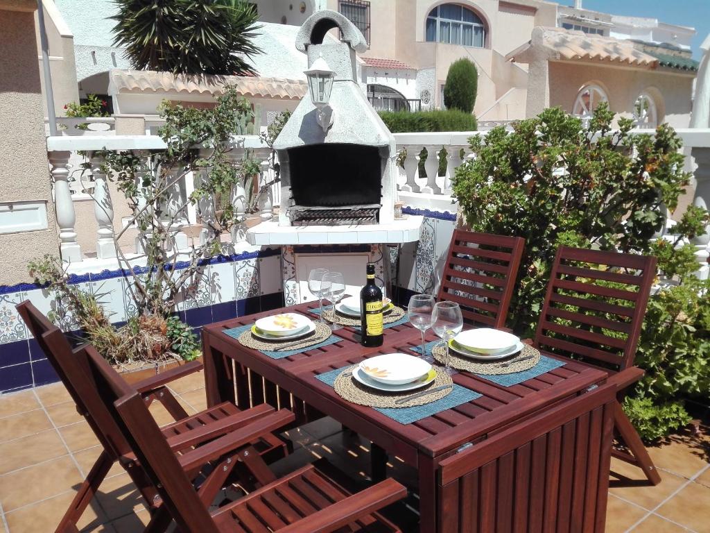 a table with a bottle of wine on a patio at Vikingo in Pilar de la Horadada