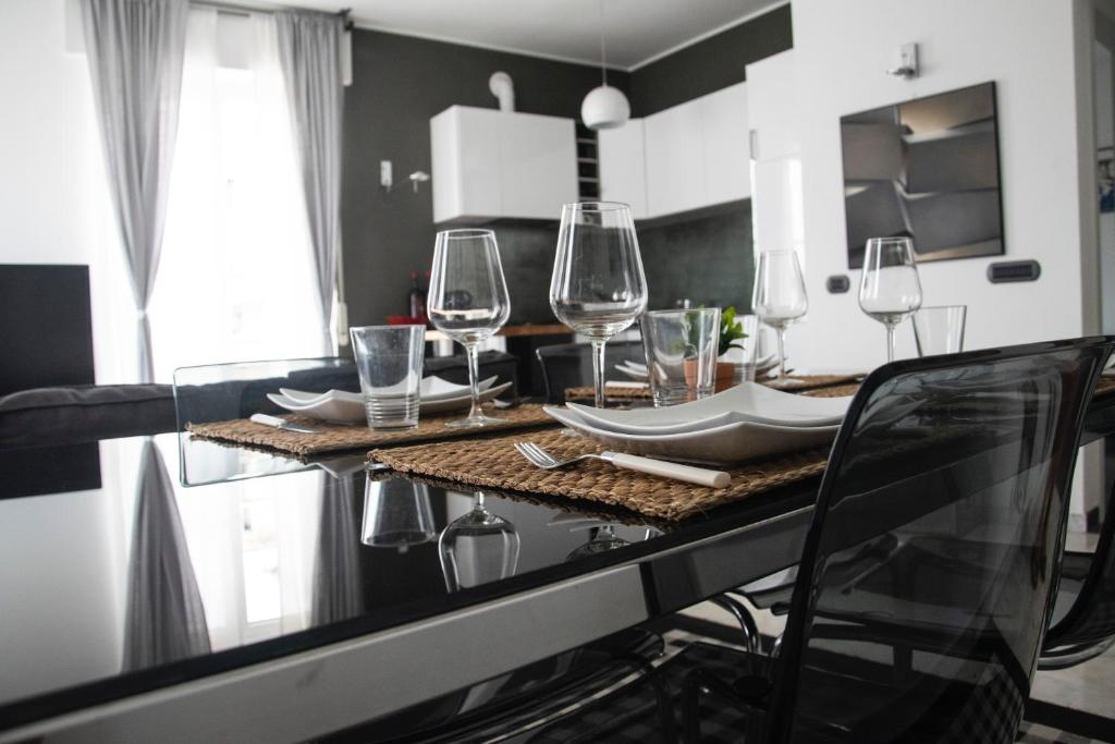 a kitchen with a table with wine glasses on it at Maison Beaux-Arts in Sanremo