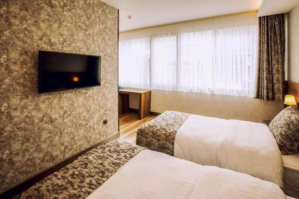 Postel nebo postele na pokoji v ubytování Life Point Hotel