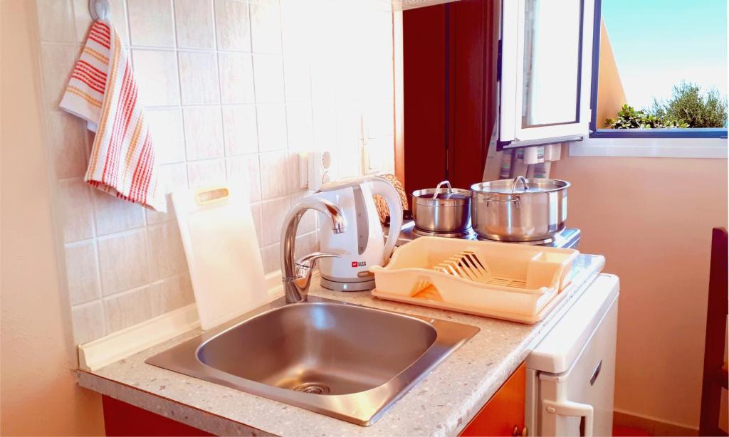 a kitchen sink with a mixer on a counter at Creta Spirit in Plakias