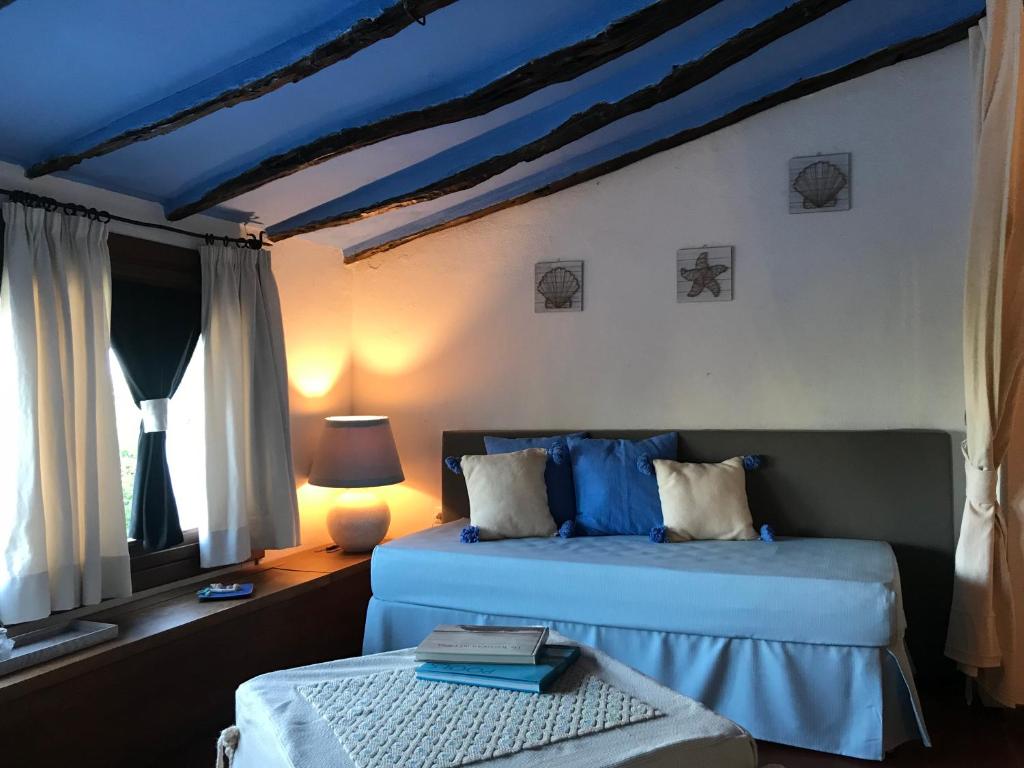 Postel nebo postele na pokoji v ubytování Palmasera Charming Suites