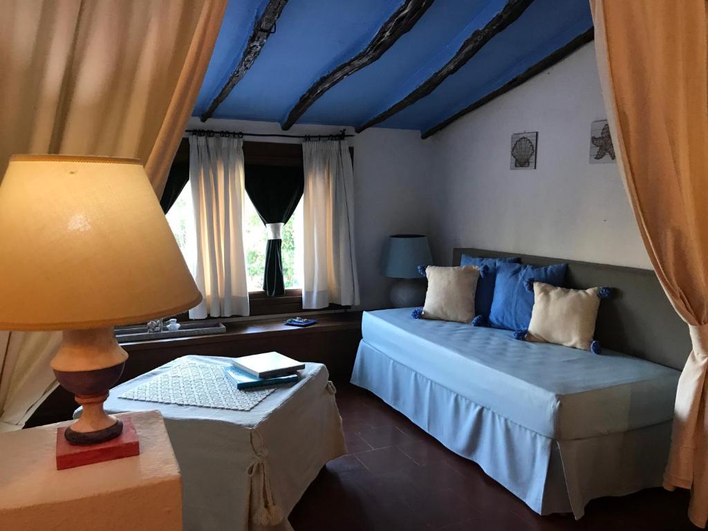 Postel nebo postele na pokoji v ubytování Palmasera Charming Suites