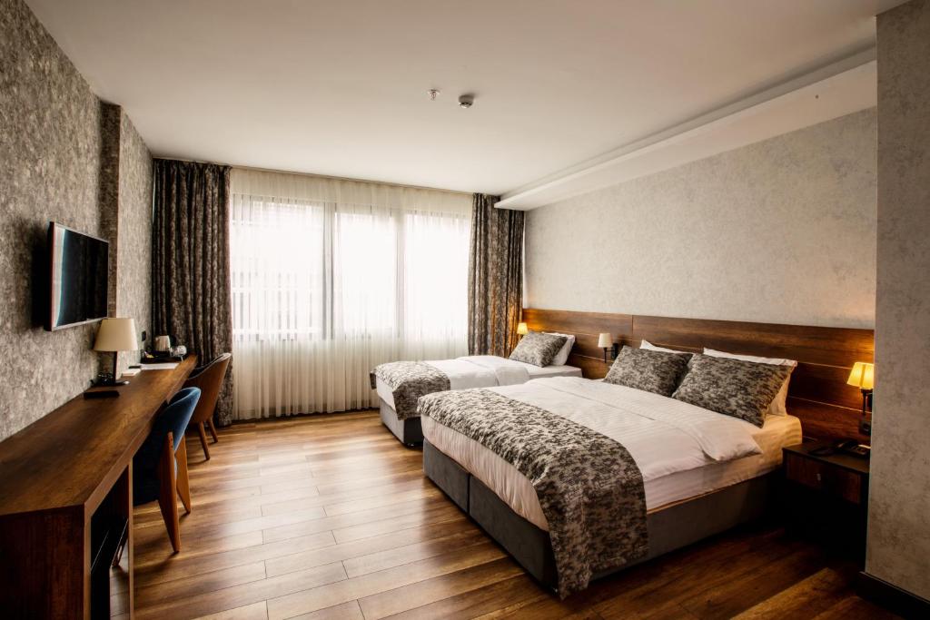 Postel nebo postele na pokoji v ubytování Life Point Hotel
