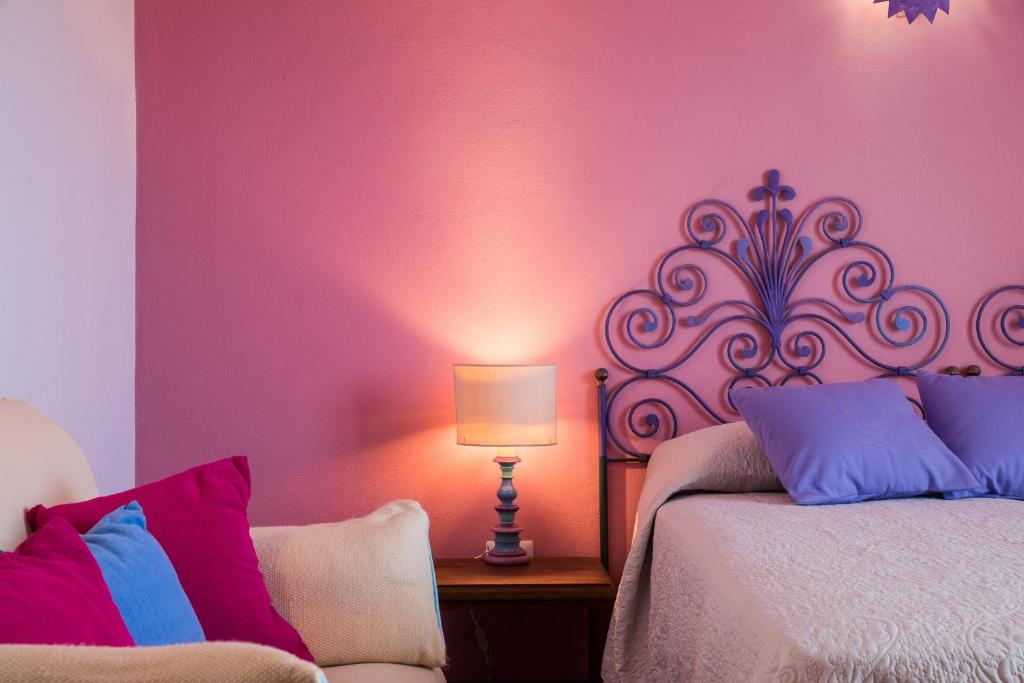 Postel nebo postele na pokoji v ubytování Palmasera Charming Suites