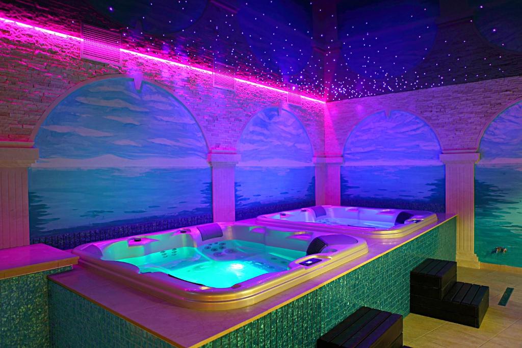 a hot tub in a room with purple lights at Hotel Forum Fitness Spa & Wellness in Lublin