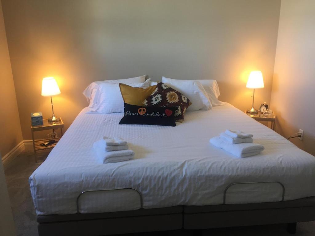 a bedroom with a large bed with towels on it at Misty Ridge Retreat B&B in Foothills