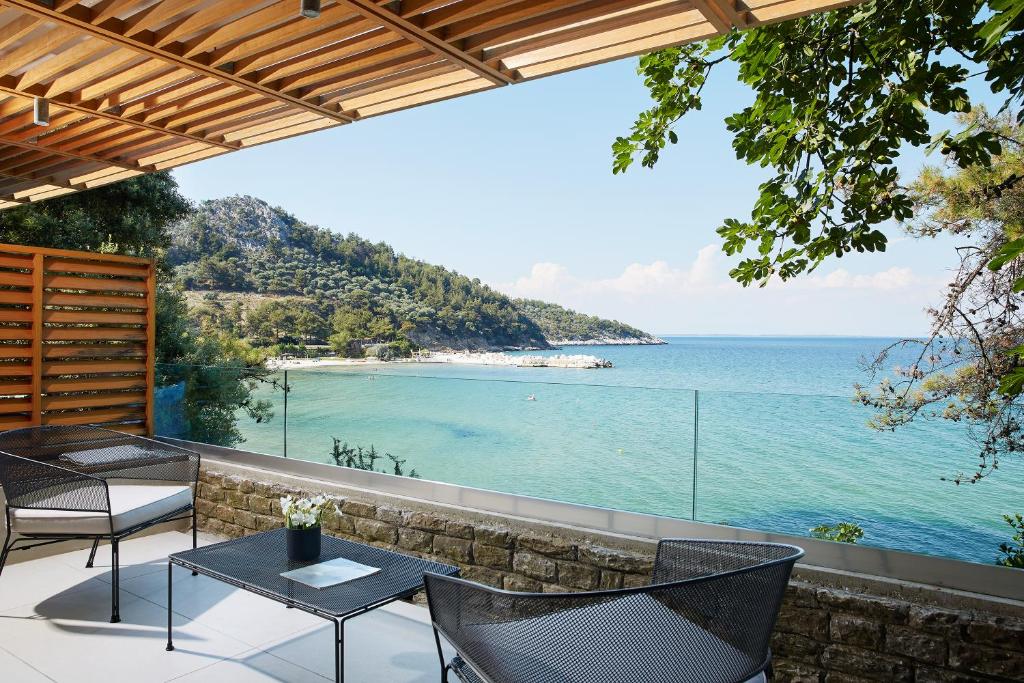 a patio with a view of the ocean at Makryammos in Limenas