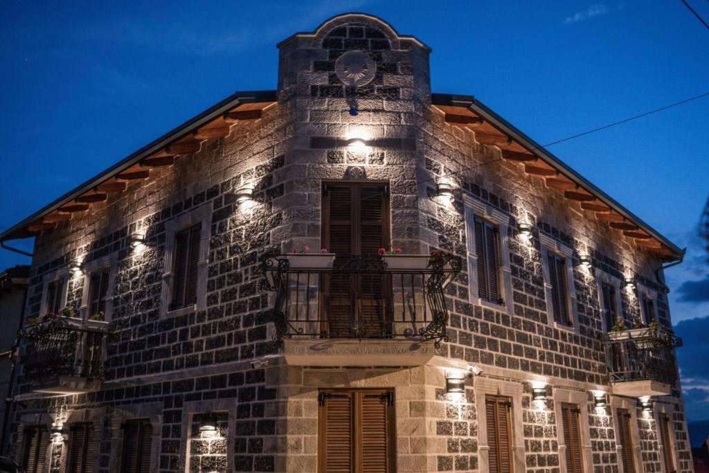 a building with a clock on top of it at Korça Boutique Hotel in Korçë