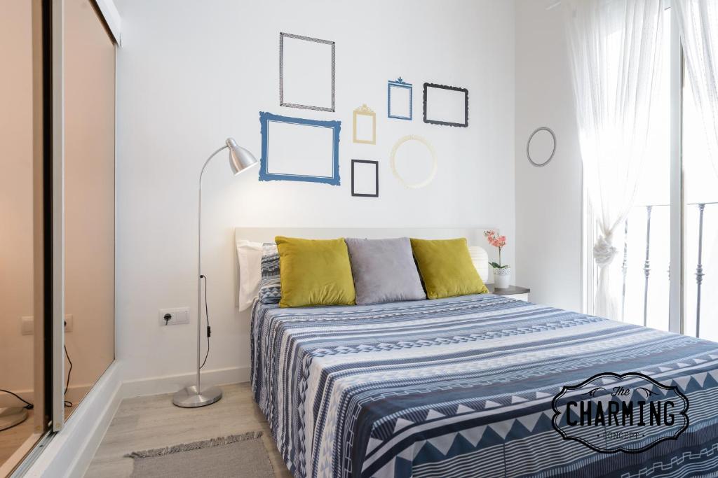 ein Schlafzimmer mit einem Bett mit einer blauen und weißen Decke in der Unterkunft Charming Atocha in Madrid