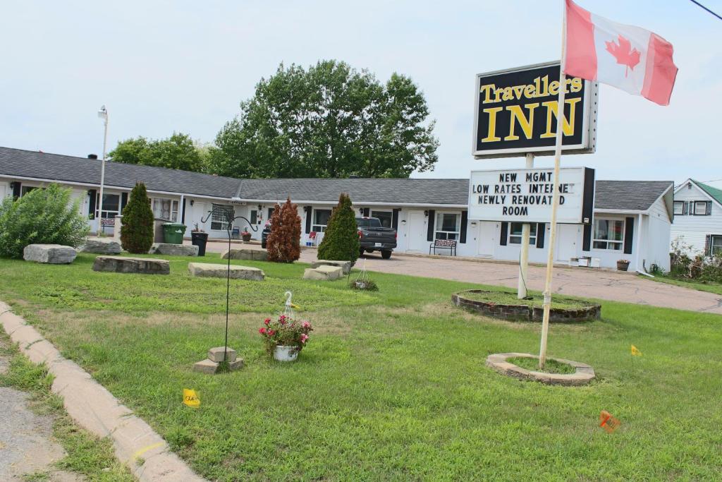 a sign in front of a inn with a sign at Travellers Inn in Pembroke