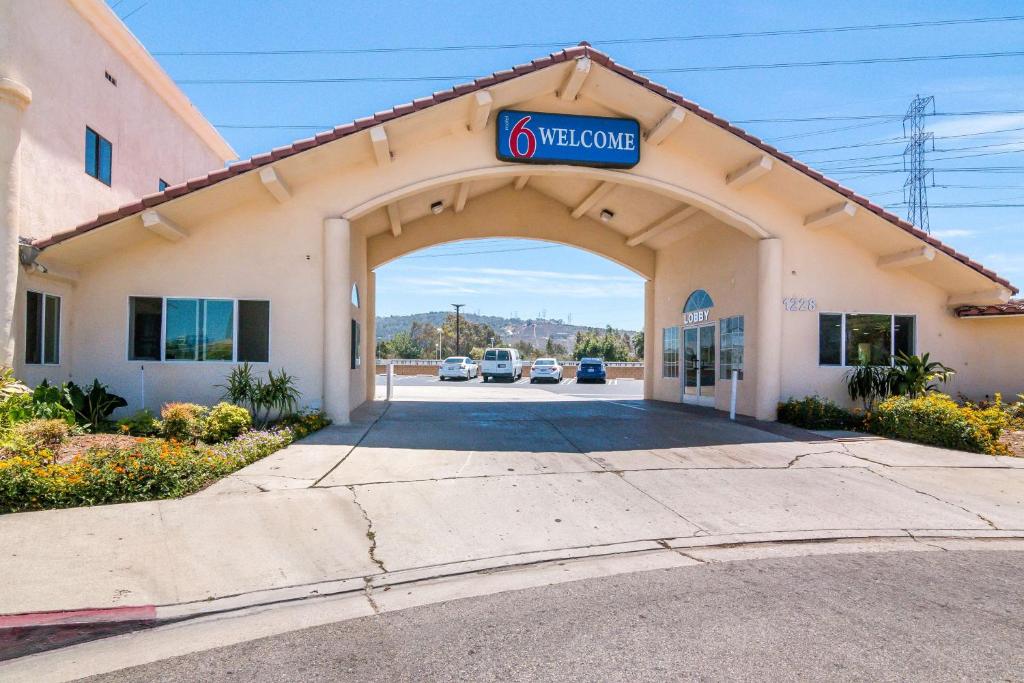 a welcome sign on the front of a building at Motel 6-South El Monte, CA - Los Angeles in South El Monte
