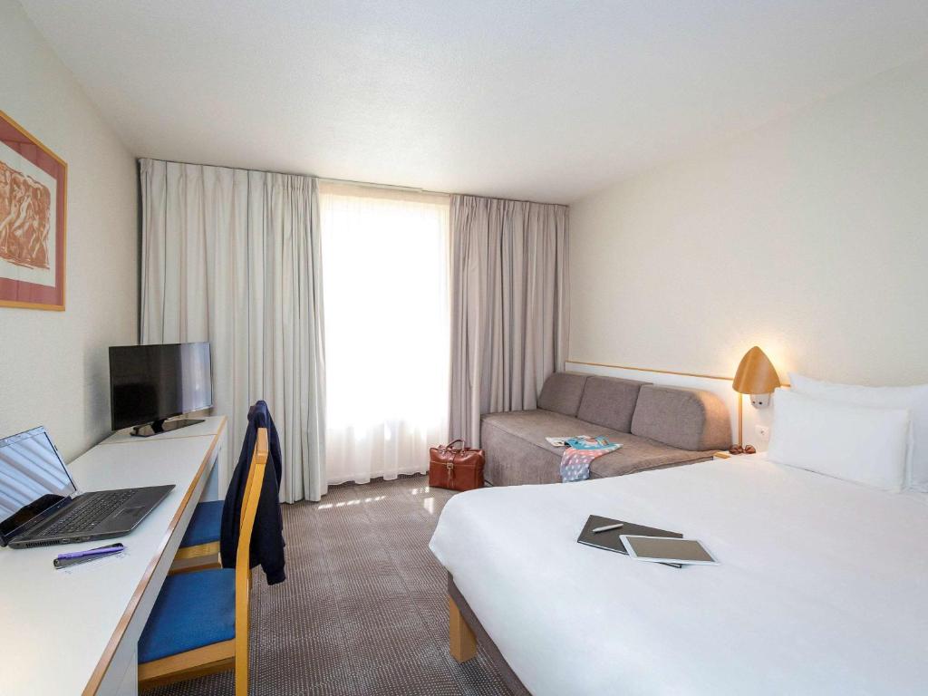 Postel nebo postele na pokoji v ubytování Novotel Perpignan Nord Rivesaltes