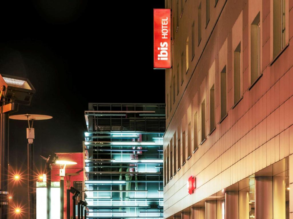 un edificio con un cartel en su costado por la noche en Hotel Ibis Łódź Centrum en Lodz