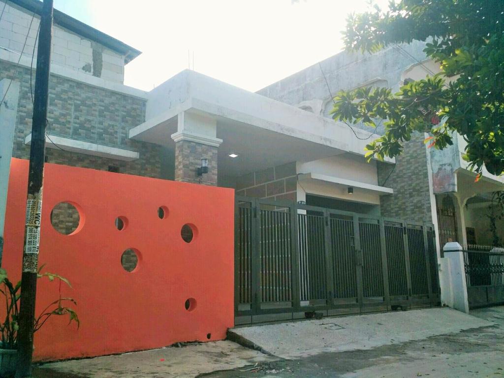 a red fence in front of a house at Homestay Bumi Asri III Cikutra in Bandung