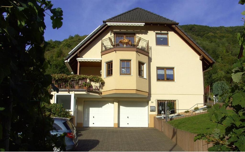 a large house with a car parked in front of it at Moselblick in Sankt Aldegund