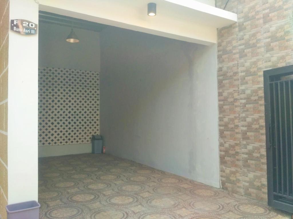 an empty room with a brick wall at Homestay Bumi Asri III Cikutra in Bandung