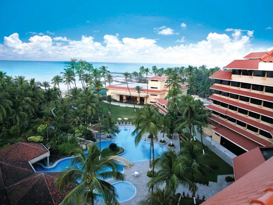 an aerial view of a resort with a pool and the ocean at The Retreat Hotel & Convention Centre in Mumbai