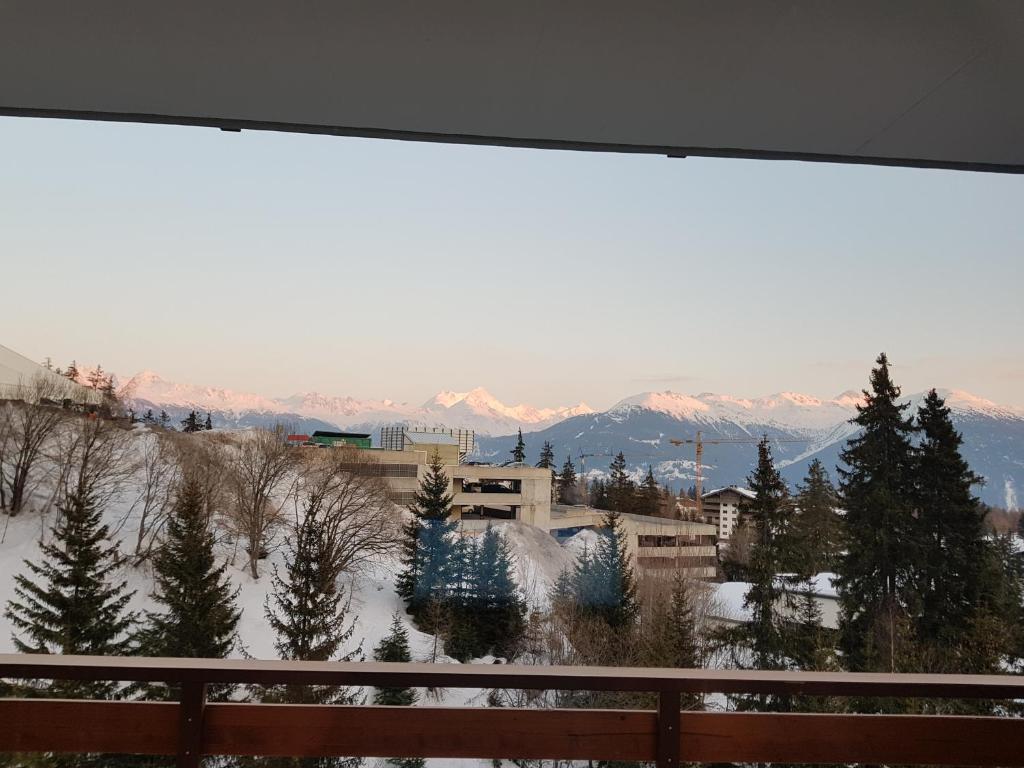 a view of a snowy mountain from a balcony at Télérésidence in Crans-Montana