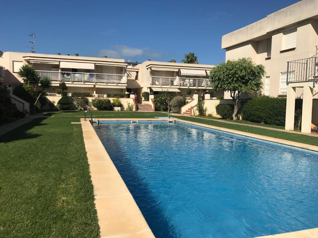 a swimming pool in front of a house at APARTAMENTO Nº 13 URB. CALA JOSEP in Vinarós