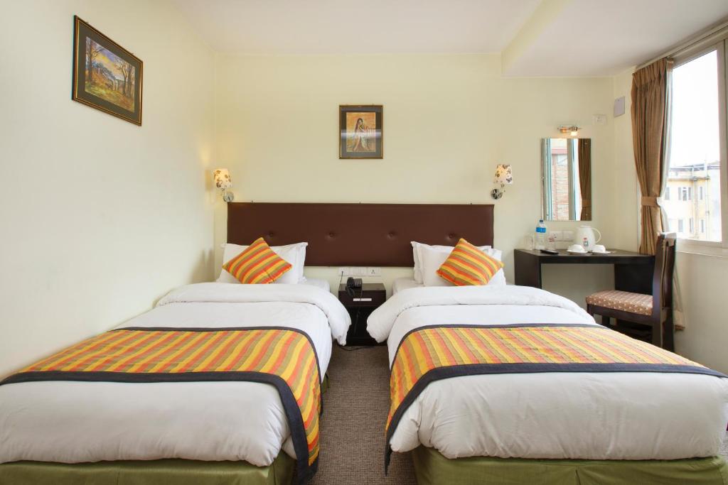 Postel nebo postele na pokoji v ubytování Hotel Serenity