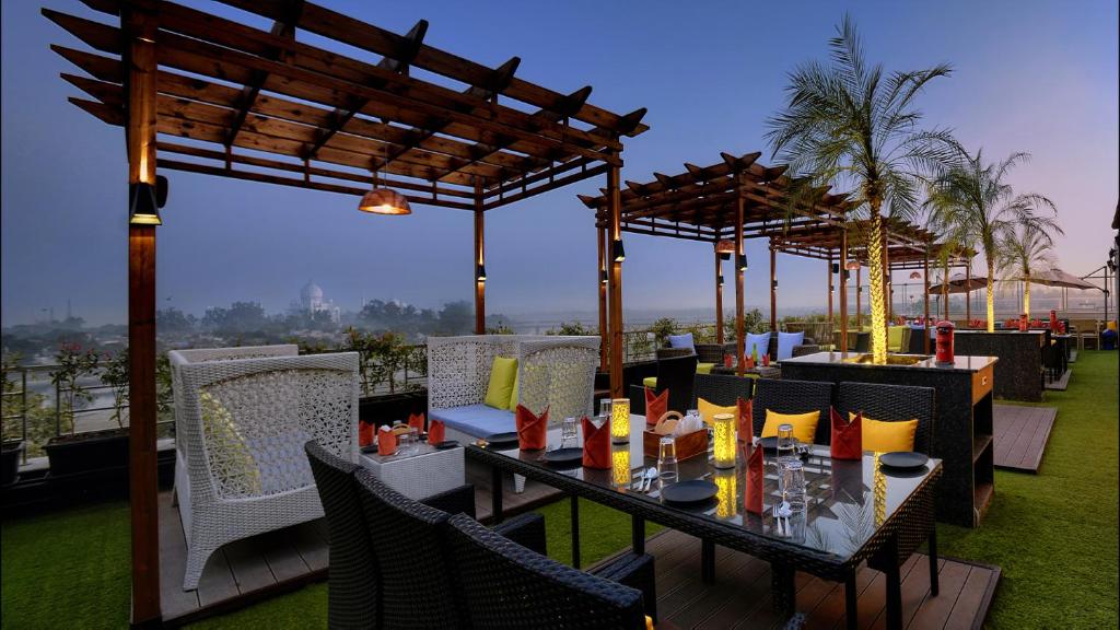 a restaurant with a table and chairs on a roof at Hotel Alleviate in Agra