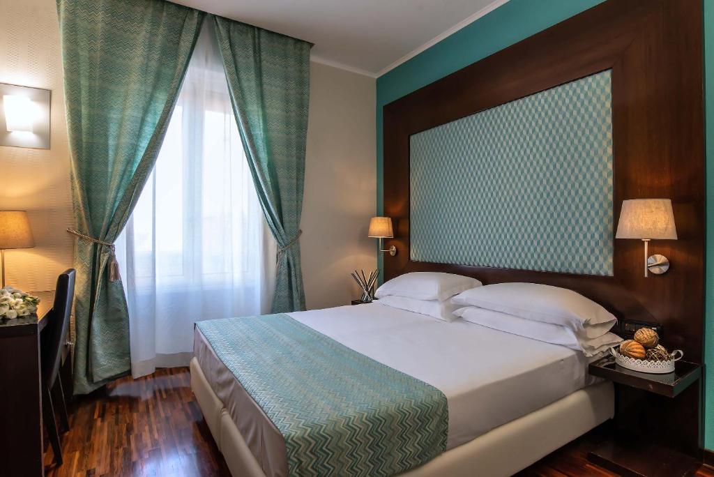 a bedroom with a large bed and a large window at Merulana Inn Guest House in Rome