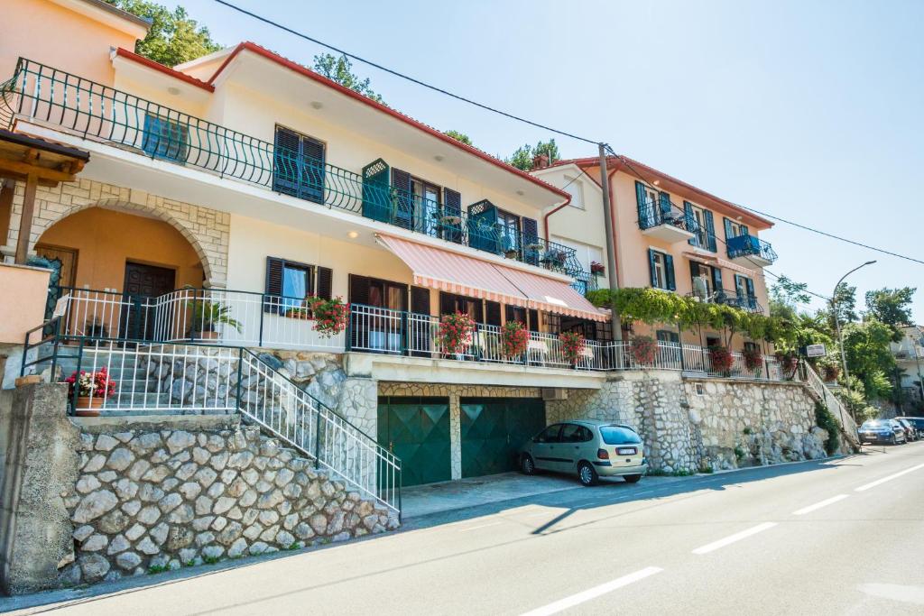 a building with a car parked in front of it at Rooms Vanda & Frane in Mošćenička Draga