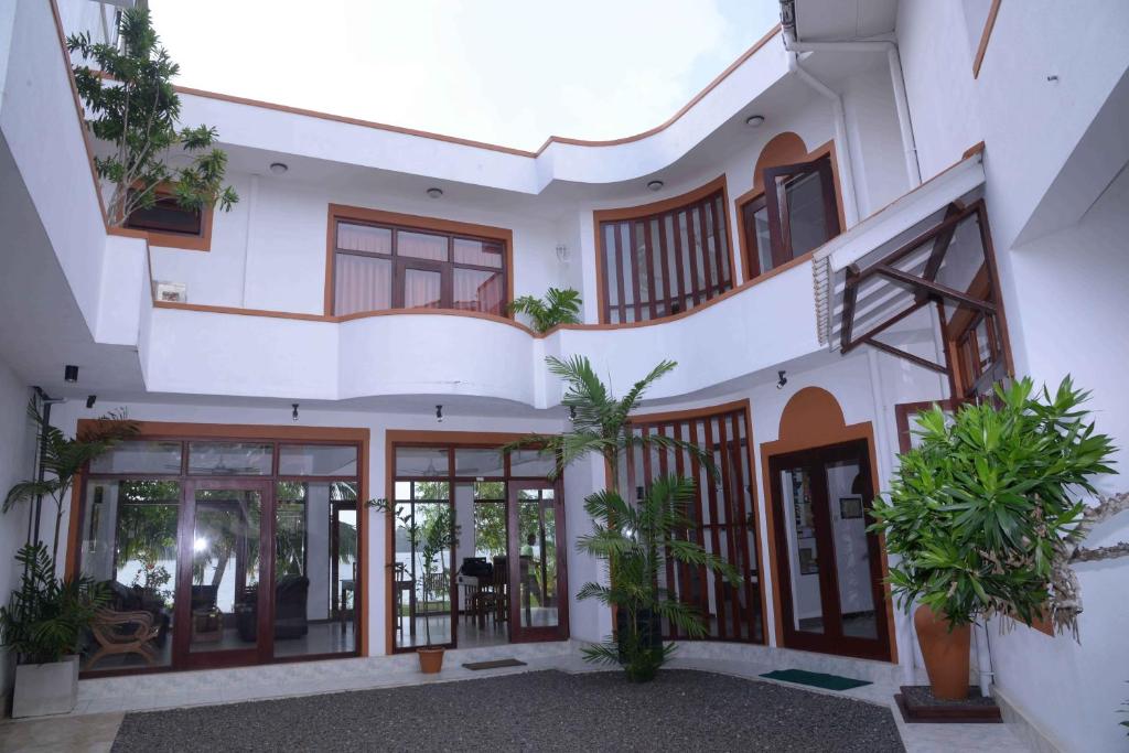 an external view of a house with plants at Riverside Inn Fuji in Bentota