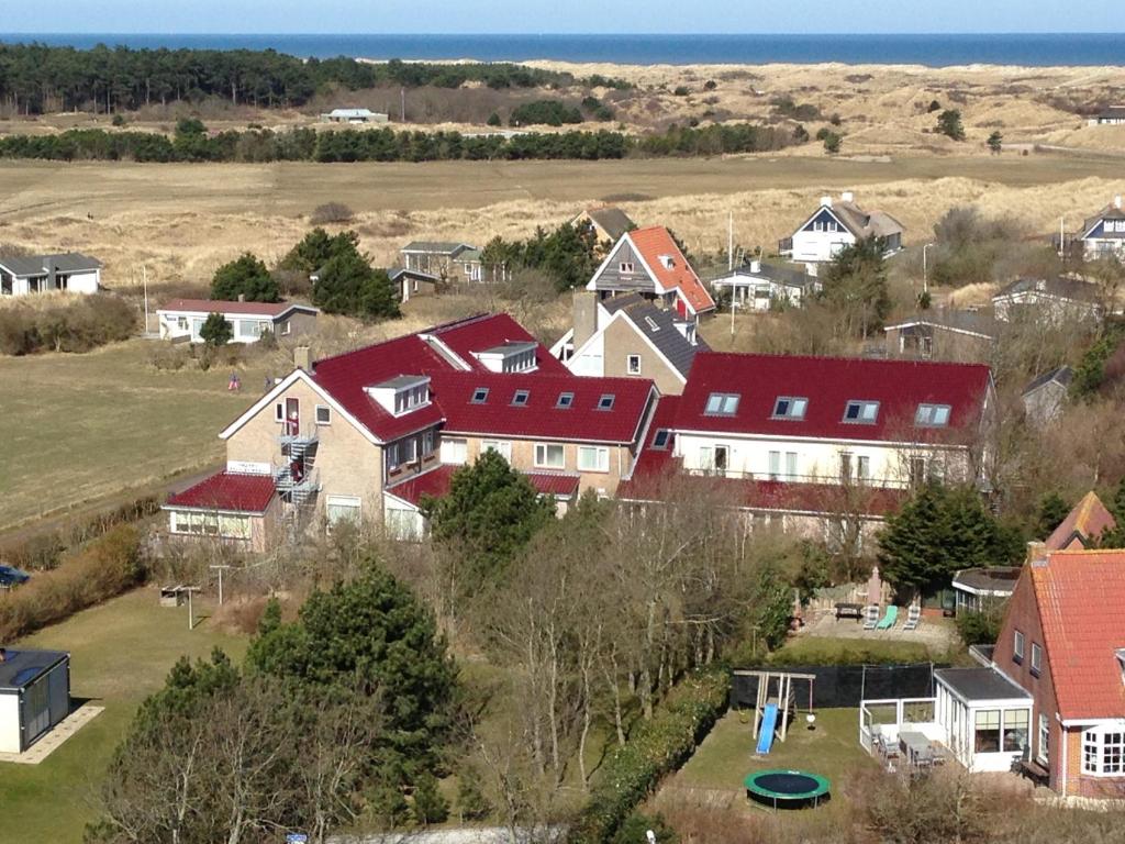 an aerial view of a house with red roofs at Hotel Bos en Duinzicht in Nes