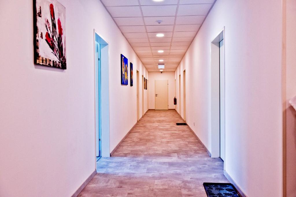 an empty corridor in an office building with white walls at Pension Waldesruh in Linz
