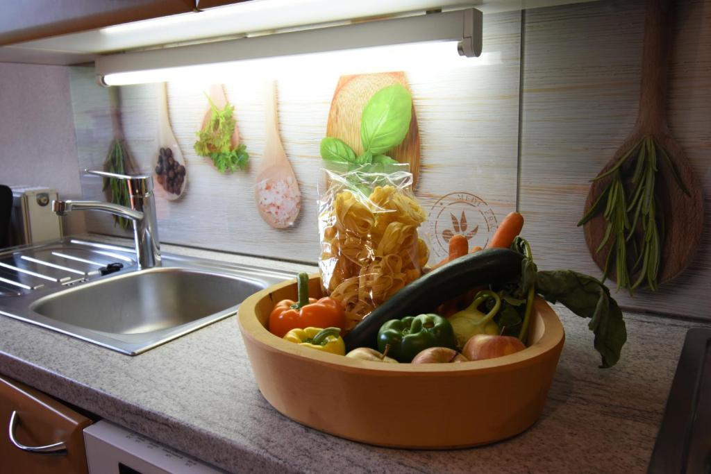 a bowl of vegetables on a counter in a kitchen at Wegscheiderhof in Mühltal