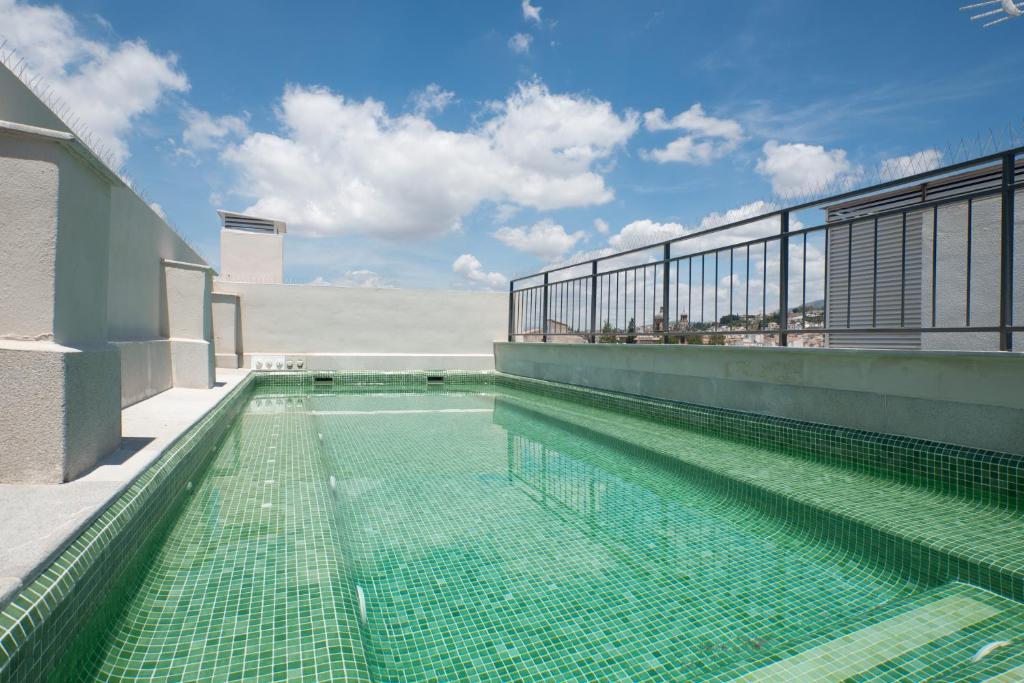 a swimming pool on the roof of a building at Granada Luxury Apartments in Granada
