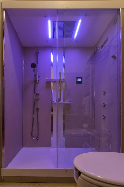 a purple bathroom with a shower and a toilet at Alla Vite Dorata in Venice