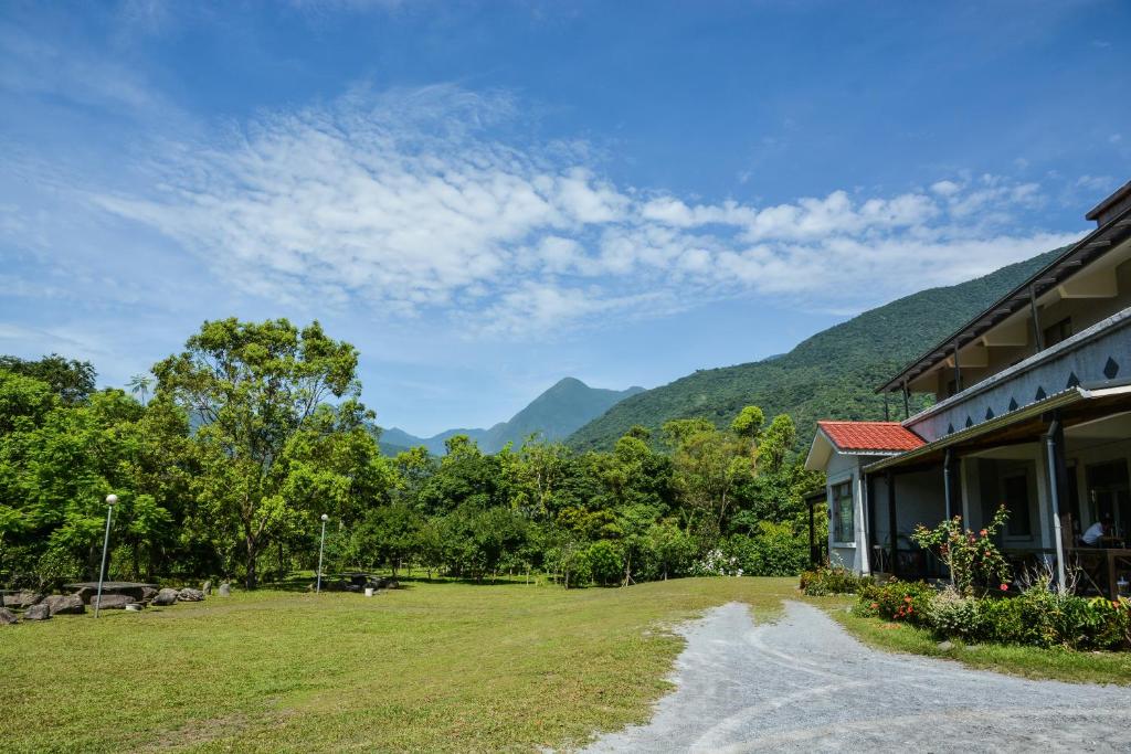 a view of a building with mountains in the background at Taroko Sialin Coffee Farm Homestay in Xiulin