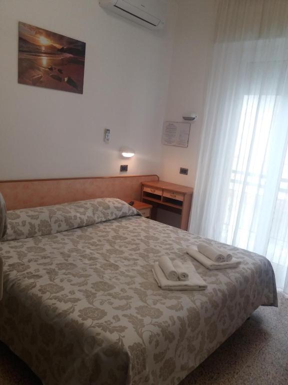 Postel nebo postele na pokoji v ubytování Hotel Zurigo