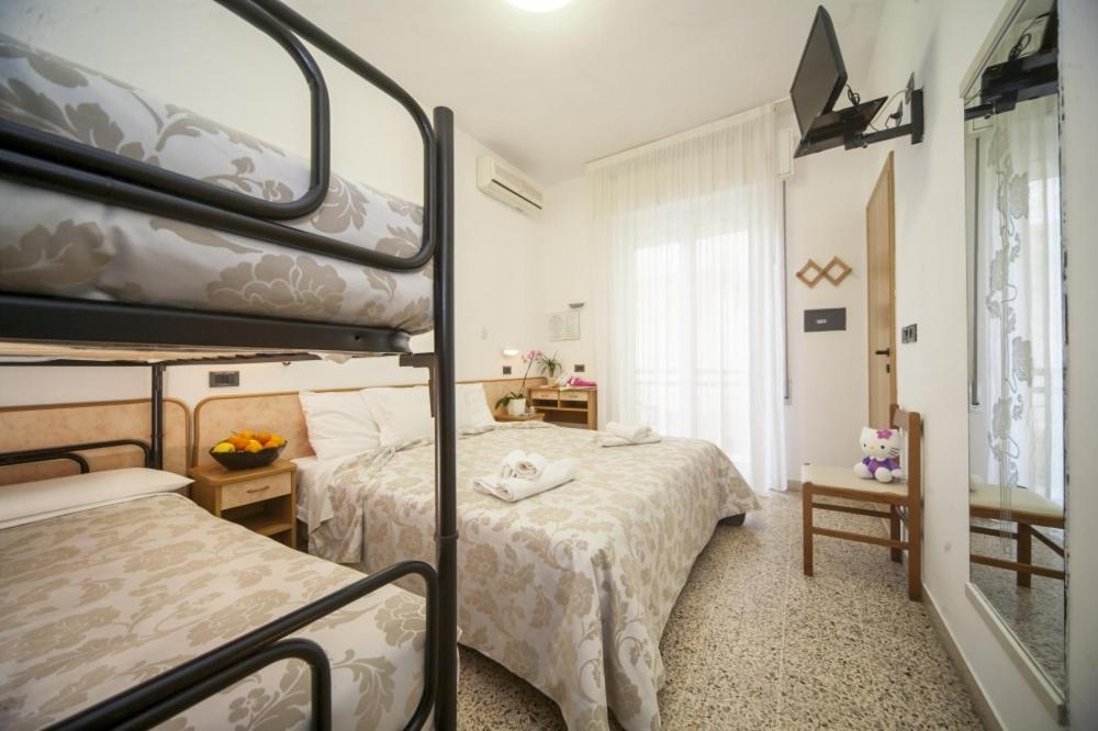 Postel nebo postele na pokoji v ubytování Hotel Zurigo