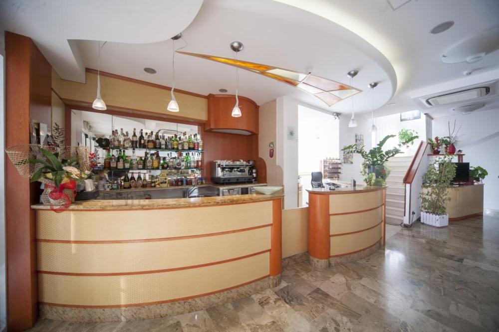 a bar in a restaurant with a counter at Hotel Zurigo in Rimini