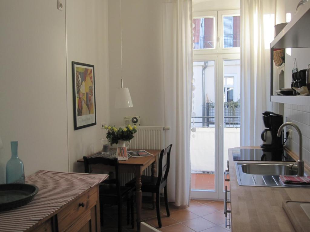 a kitchen with a table with chairs and a dining room at Berlin Prenzlauer Berg in Berlin