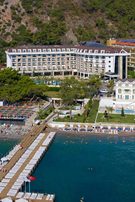 an aerial view of a hotel and the water at Sunland Resort Beldibi in Kemer