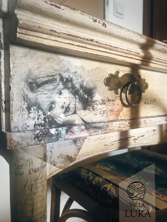 a painting of a horse on a wooden frame at Apartments Villa Luka in Sveti Stefan