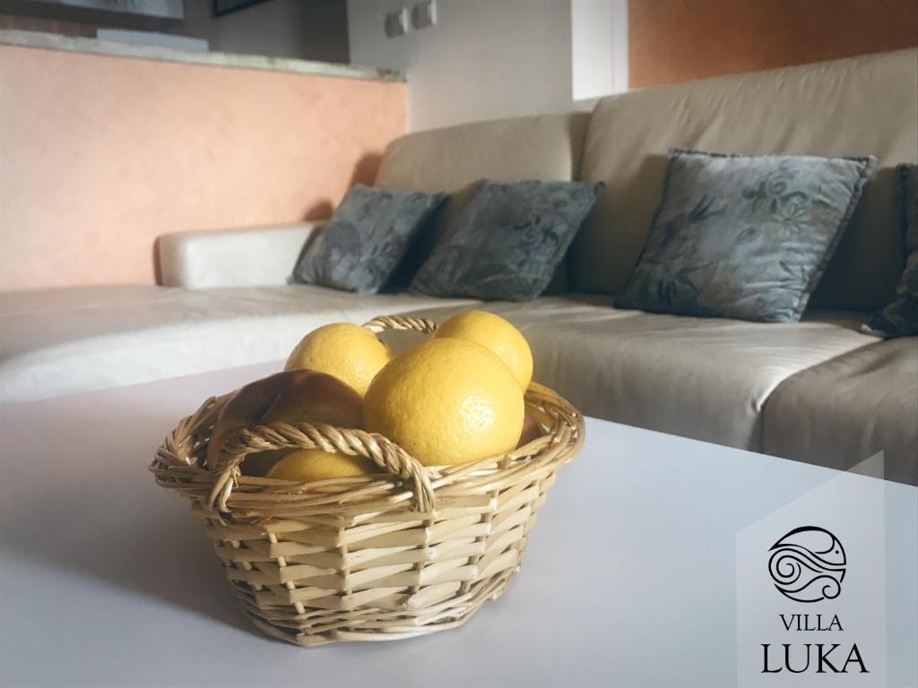 a basket of fruit on a table in a living room at Apartments Villa Luka in Sveti Stefan