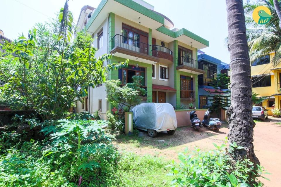 a house with a motorcycle parked in front of it at Menezes House in Panaji