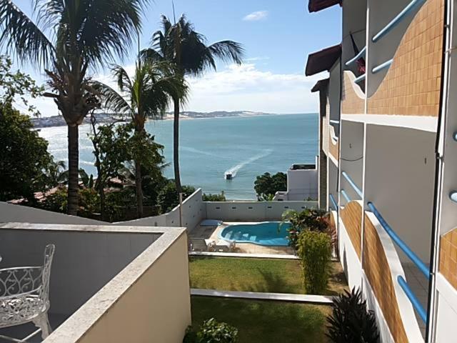 a view of the ocean from a balcony of a house at Hotel Pousada Estacao Do Sol Natal in Natal
