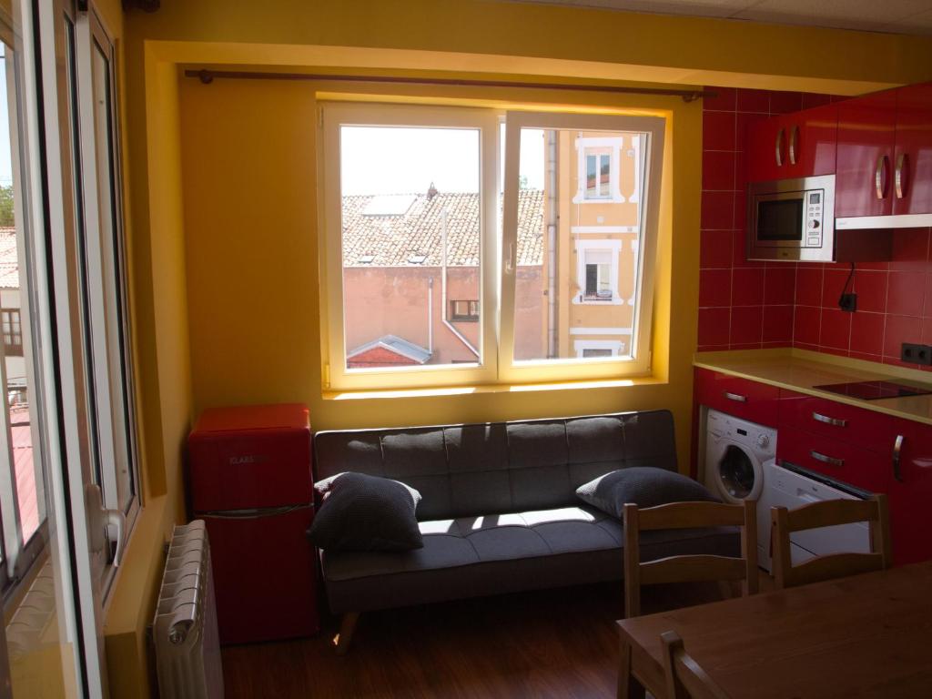 a living room with a couch in front of a window at Jimena in Burgos