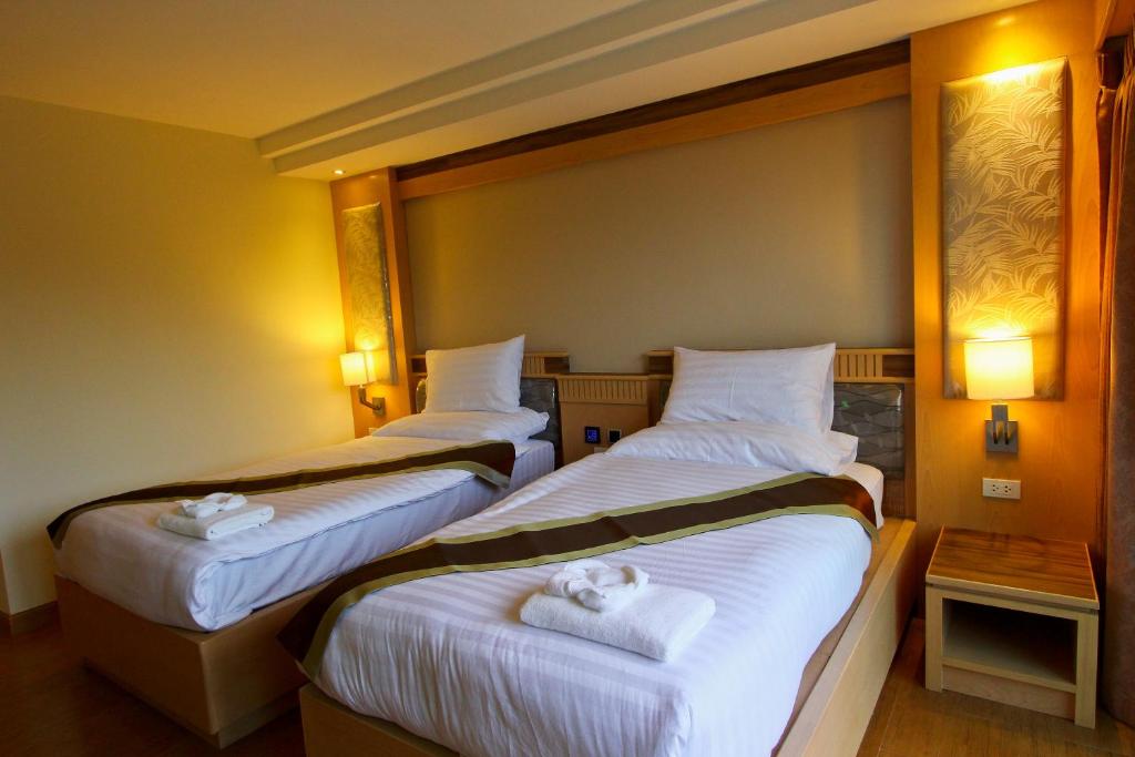 Postel nebo postele na pokoji v ubytování Kitlada Hotel Udonthani