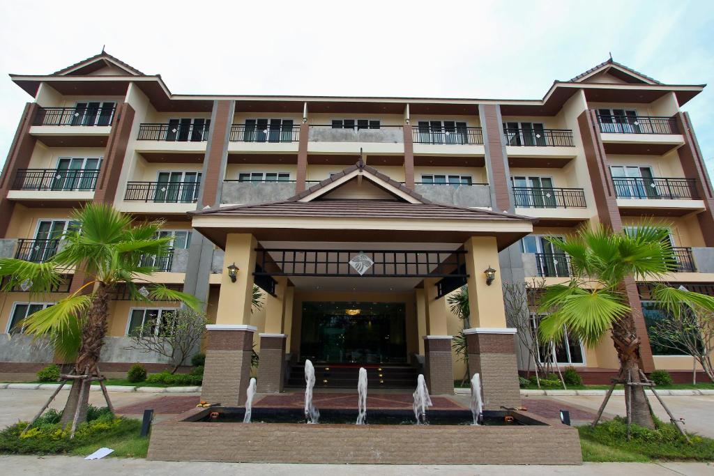 a building with a fountain in front of it at Kitlada Hotel Udonthani in Udon Thani